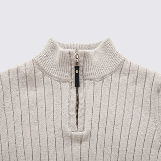 Close-up of a light gray ribbed sweater with a quarter zip on a light gray background