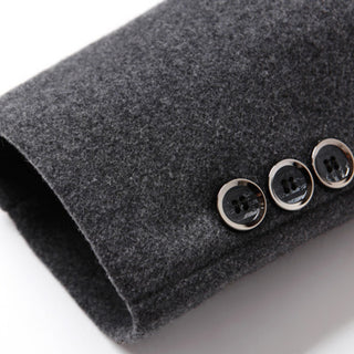 Close-up of a gray coat with three buttons on a white background