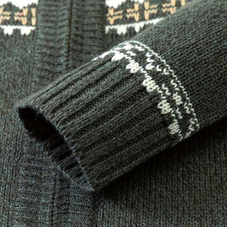 Close-up of a dark gray sweater with patterned cuffs and hem.