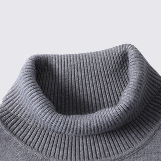 Close-up of a gray knit sweater collar on a light gray background