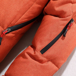 Close-up of an orange puffer jacket with zippers on a light gray background