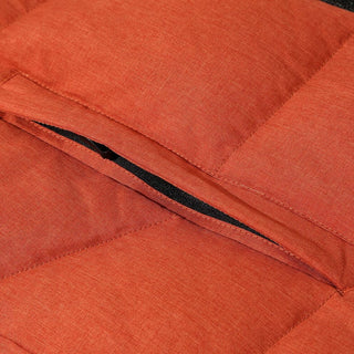 Close-up of an orange quilted jacket with a zipper