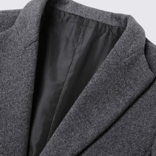 Close-up of a gray coat with a black lining on a light gray background