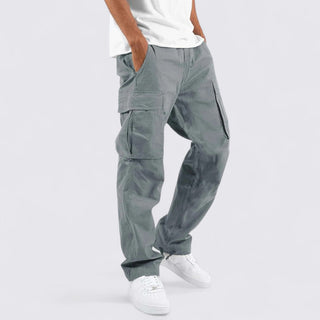 Person wearing gray cargo pants on a white background