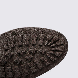 Close-up of a textured brown sole on a light gray background