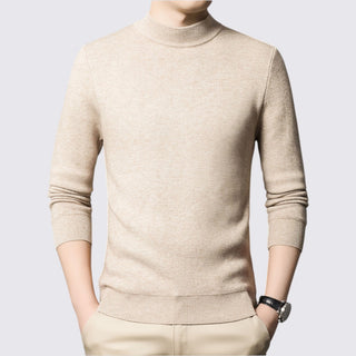 Beige turtleneck sweater worn by a person on a light gray background