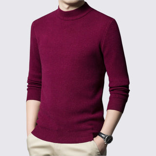 Maroon turtleneck sweater worn by a person on a light gray background
