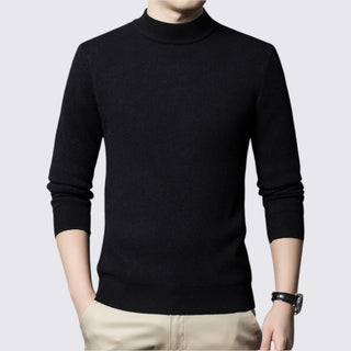 Black turtleneck sweater worn by a person on a light gray background