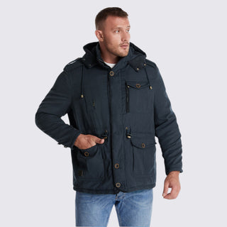 Man wearing a dark blue jacket with multiple pockets on a light gray background