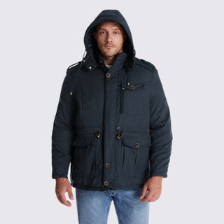 Man wearing a dark blue hooded jacket on a light gray background