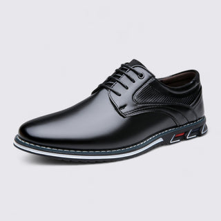 Black leather dress shoe on a light gray background