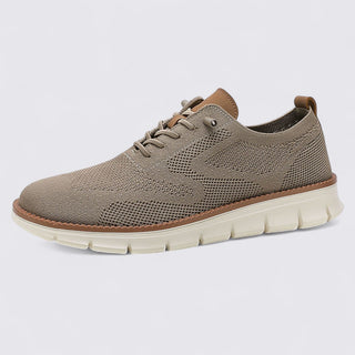 Brown sneaker with white sole on a light gray background