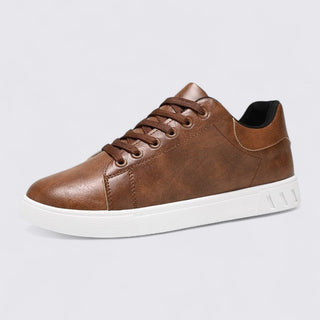 Brown leather sneaker with white sole on a light gray background