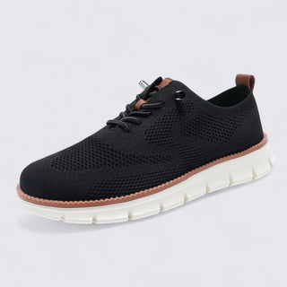 Black sneaker with white sole on a light gray background