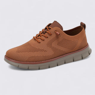 Brown sneaker with a textured sole on a light gray background